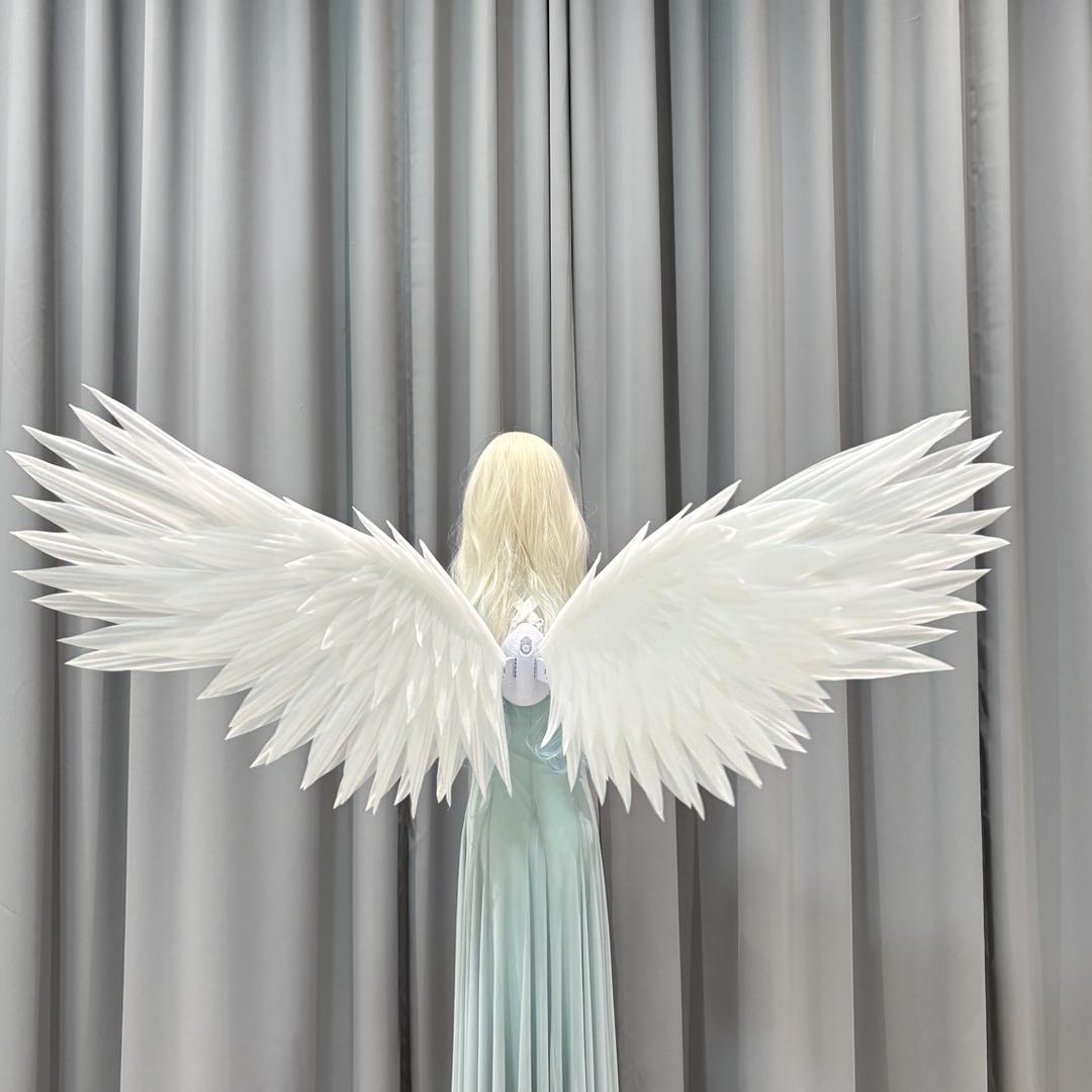 White classic angel wings worn with a flowing dress
