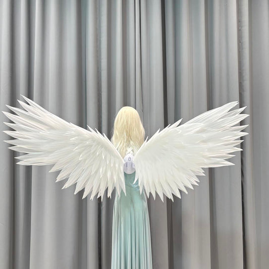 White classic angel wings worn with a flowing dress
