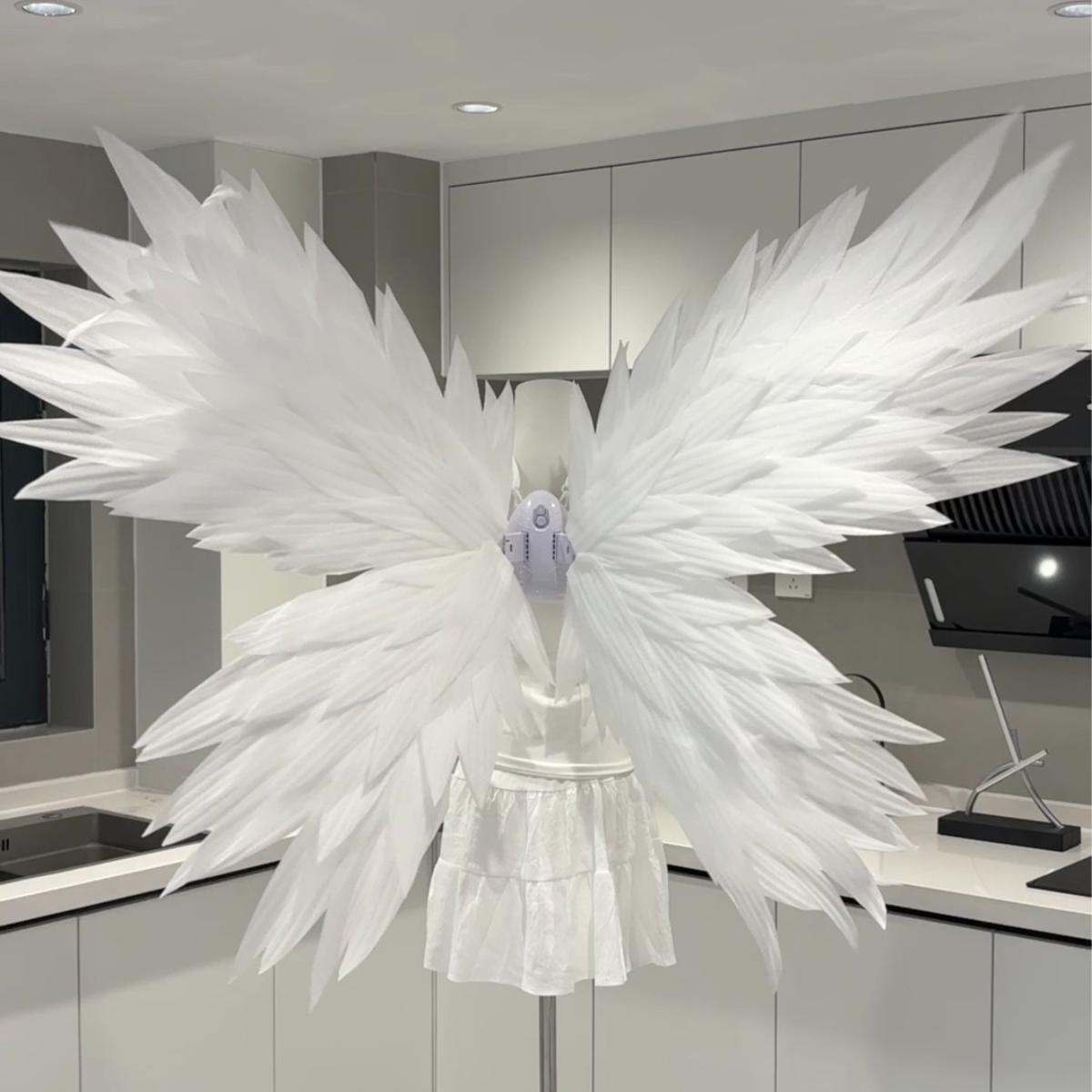 White butterfly-style angel wings on a mannequin
