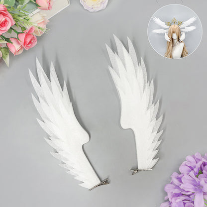 Pair of white angel wing hair clips with layered wing shapes
